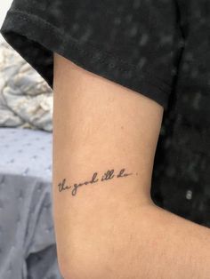 a person with a tattoo on their arm that says, the good life is here