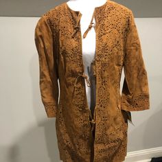 This Chi By Falchi Genuine Suede Leather Jacket Has A Mandarin Collar With Beautiful Cut Out Detailing And Ties Up The Front. Stylish And Lightweight. It Is Absolutely Stunning! Fully Lined. Measures 20.5” Across Back And 31” Long In Back. This Is Brand New And May Need To Be Hung Up To Get Any Creases Out. Or A Very Light Steam Would Do The Trick Suede Leather Jacket, New Cut, Camel Color, Mandarin Collar, Leather Coat, Suede Leather, Steam, Camel, Cut Out