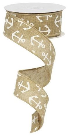 a roll of beige ribbon with white anchors on it