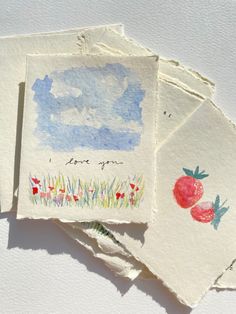 four cards with watercolor drawings on them