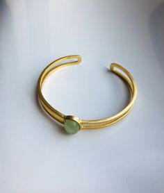 A piece of stylish & modern look gold bangle, which is made with genuine 100% natural real light green Chinese jade bead and 14k gold plated 925 sterling silver bracelet. A great combination of charm and elegance. The minimalistic design is great for your daily wear or special occasions. Perfect as a gift for your loved ones or just as a treat yourself :) Some Highlights of this gold jade bead cuff are: ＊High-quality Material Only 100% natural green jades paired with solid 925 sterling silve Chinese Jade, Jade Ring, Natural Jade, Beaded Cuff, Jade Jewelry, Jade Beads, Silver Flowers, Gold Bangles, Beaded Pendant