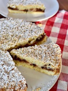 two plates with desserts on them sitting on a red and white table cloth next to each other