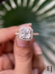 a close up of a person holding a ring with a diamond in it's center