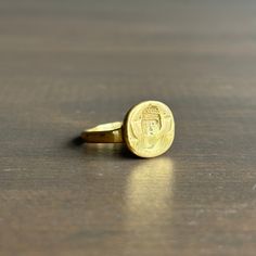 The regal gaze of an empress peers out from the face of this ring, cast from an original engraved bronze ring from the late Roman/Byzantine period, approximately 300-600 AD. 22k yellow gold Ring face is 13mm x 12mm (~9/16" x 1/2") Spiritual Yellow Gold Engraved Ring In Brass, Spiritual Engraved Yellow Gold Ring In Brass, Spiritual Yellow Gold Engraved Brass Ring, Spiritual Carved Gold Ring, Spiritual Gold Carved Rings, Byzantine Yellow Gold Engraved Signet Ring, Gold Byzantine Carved Jewelry, Byzantine Engraved Yellow Gold Rings, Byzantine Style Engraved Yellow Gold Ring