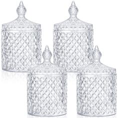 four clear glass canisters with diamond design on the top and one has a lid