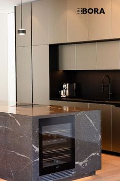 a kitchen with marble counter tops and an oven in the center, surrounded by stainless steel appliances