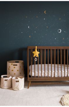 a baby's room with a crib and stars on the wall