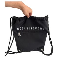 MOSCHINO COUTURE Black Rectangular Men's Sack Backpack AW20 collection by Jeremy Scott 100% Moschino Authentic!!! Condition: Brand new with Moschino tags, Moschino dust bag included Color: White/Black Material: 100% Nylon Measurements: 12"x 15.5" Shoulder straps Logo to the front One zipped pocket to the front One internal pocket and patched credit card slot pocket Solid color Drawstring Closure Everything we sell is 100% Genuine and Authentic products! GUARANTEED 100% AUTHENTIC or 50X your mone Moschino Couture, Elsa Schiaparelli, Jeremy Scott, Gianni Versace, Backpack Purse, Fashion Handbags, Moschino, Zip Pockets, Dust Bag