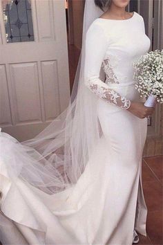 a woman in a white wedding gown and veil