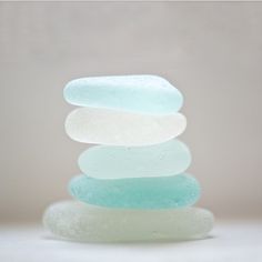 a stack of soap bars sitting on top of each other in front of a white background