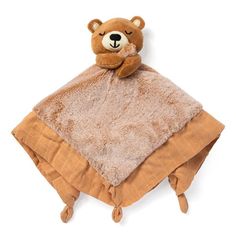 a brown teddy bear sitting on top of a blanket