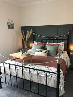 a bedroom with a metal bed frame and headboard