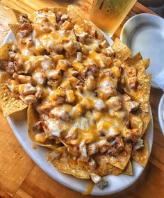 a plate filled with nachos covered in cheese