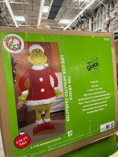 the grinch costume is on display in a store's cardboard box for sale