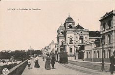 an old black and white photo of people walking down the street in front of buildings