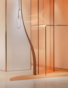 a bathroom with a glass shower stall next to a white wall and flooring area