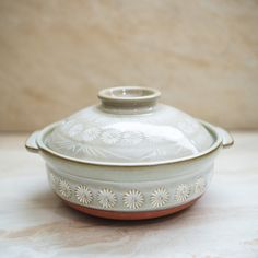 a white and brown bowl sitting on top of a table