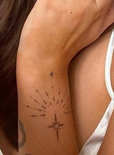 a woman with a star tattoo on her arm