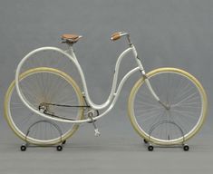 a white and yellow bicycle is shown on a gray background