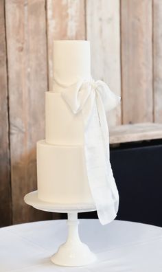 a white wedding cake with a bow on top