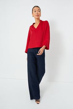 Effortlessly elevated, the Red Phillipa Blouse is a feminine silhouette that can be styled for countless occasions. This top drapes off the body in the most flattering way and features a stand collar with a gathered neckline, bracelet length sleeves, and a lightweight fabric that feels soft to the touch. Opt for dark wash denim and heels for date night and swap for trousers and flats for a day in the office. Stand collar V-neckline Gathering on neckline and back Wide sleeves Bracelet length slee Red Collared Blouse For Fall, Red Collar Blouse For Work, Chic V-neck Top With Gathered Neckline, Chic Stretch Tops With Gathered Neckline, Chic Stretch Top With Gathered Neckline, Elegant Long Sleeve Top With Gathered Neckline, Spring Stretchy Tops With Gathered Neckline, Chic Red Blouse For Work, Chic Workwear Blouse With Gathered Neckline