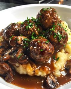 some meatballs and mashed potatoes on a white plate