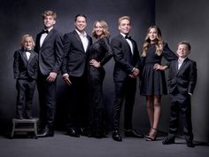 a group of people in formal wear posing for a photo