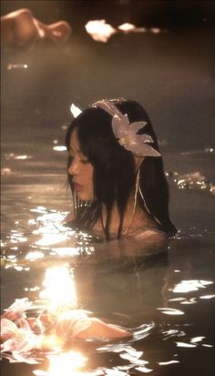 a woman is floating in the water with her head down