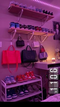 shoes and handbags are displayed on shelves in a room with purple lighting behind them