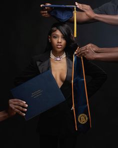 the woman is holding her diploma and posing for a photo