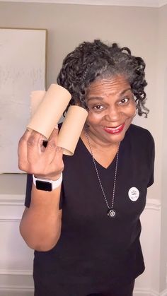 a woman holding two rolls of toilet paper