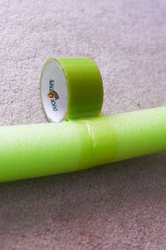 a roll of neon green tape sitting on the floor