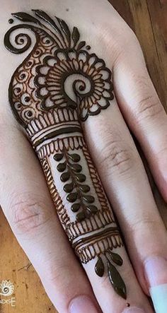 a woman's hand with henna on it