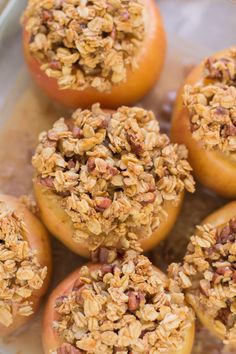 baked apples with granola on top in a baking dish