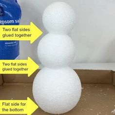 a snowman made out of foam sitting on top of a cardboard box