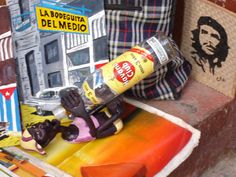 an assortment of art and crafts on display in a store window, including a skateboard