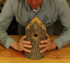 a man holding a birdhouse in his hands