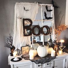 a white dresser topped with lots of halloween decorations