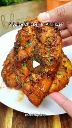 someone is holding up some food on a plate with the words, 5 spice chicken in air fryer