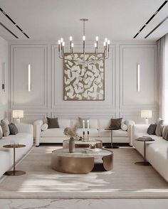 a living room with white couches, tables and lamps on the wall above them