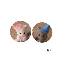 two small stuffed animals with hats on their heads