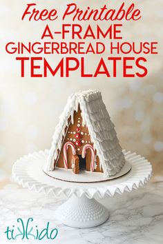 a white plate topped with a gingerbread house covered in icing