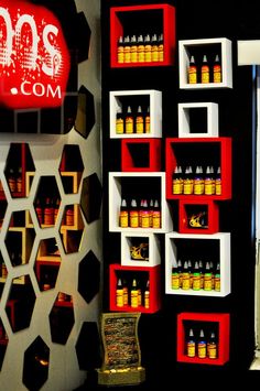 the shelves are filled with different types of liquors and bottles in red, white, and yellow colors