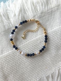 FOR OTHER DAINTY BEADED BRACELETS: https://www.etsy.com/ca/shop/ArtiChouXCanada?ref=seller-platform-mcnav%C2%A7ion_id§ion_id=46088511 Bracelet Length: 13-18cm (5.1-7 inches) with a 14k gold filled extender. But if you require a different size or prefer a personalized touch, please don't hesitate to get in touch. This bracelet features beautiful deep blue colors: blue sapphire gemstones, faux pearls and gold plated seed beads.  Thread may be visible since it is a handmade product   SIZING  Wrap a Blue And Gold Beaded Bracelets, Blue And Gold Bracelets, Navy Blue Bracelet, Gemstone Bracelet Ideas, Blue Bracelet Beads, Beaded Bracelets Blue, Gold Beads Bracelet, Pearls Bracelet, Blue Beaded Bracelets