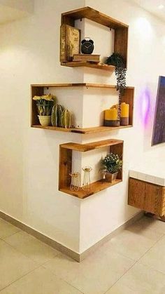 three wooden shelves on the wall in a room