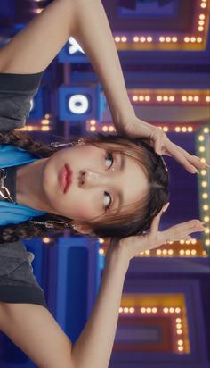 a young woman posing in front of neon signs