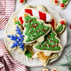 decorated christmas cookies on a plate with candy canes