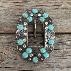 Antique Silver berry style cart buckle decorated with Clear and fashion Turquoise Howlite stones. This buckle measures 2" x 2 3/4" and will fit 5/8" to 3/4" wide leather. Perfect for breastcollar, headstalls, etc. Lifetime guarantee on all crystals Adjustable Turquoise Western Belt Buckles, Blue Concho Western Belt Buckles, Western Style Blue Concho Belt Buckles, All Crystals, Buckles Fashion, Howlite Stone, Wild Rag, Turquoise Howlite, Deep Red