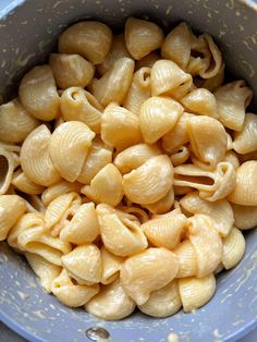 a blue bowl filled with macaroni and cheese