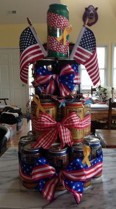 a cake made out of cans with american flags on top and ribbons tied around them